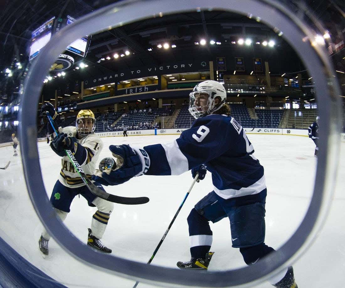 Mar 14, 2021; South Bend, IN, USA; Penn State's Alex Limoges (9) at Compton Family Ice Arena, Notre Dame's Jesse Lansdell (age 14) Reach out for the puck while defending.